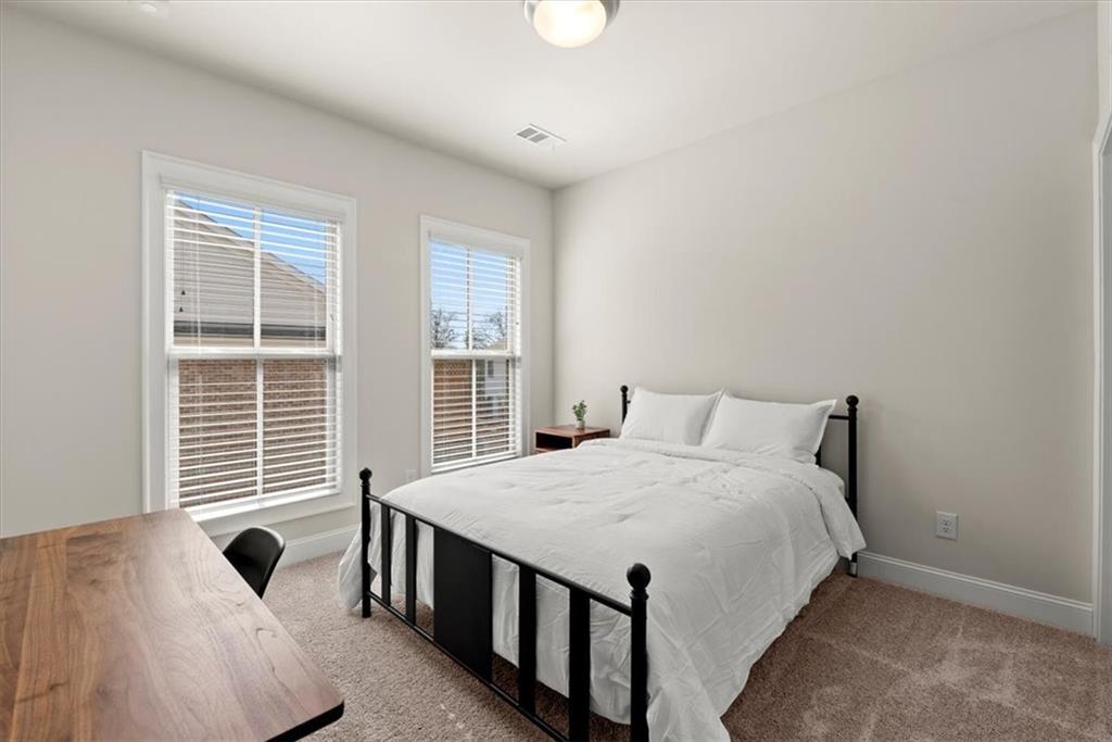 4217 Deming Circle Atlanta, GA 30342 - Photo 18 of 36 a bedroom with a bed and a window