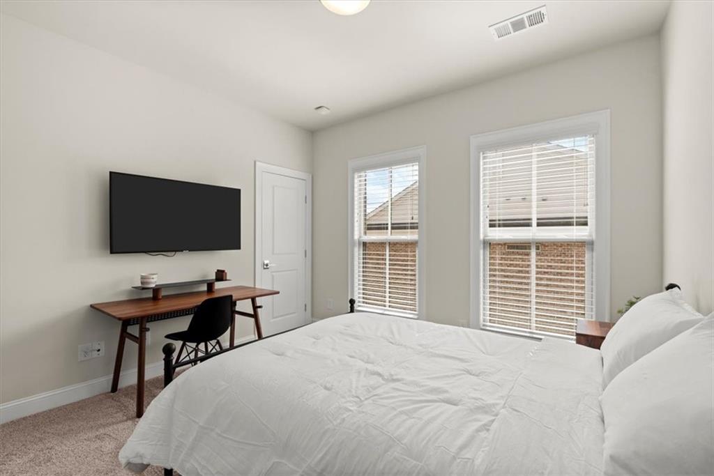 4217 Deming Circle Atlanta, GA 30342 - Photo 22 of 36 a bedroom with a bed and a flat screen tv