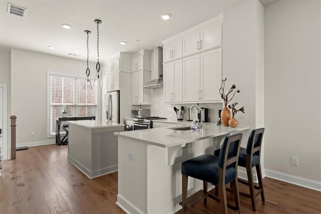 4217 Deming Circle Atlanta, GA 30342 - Photo 9 of 36 a kitchen with stainless steel appliances granite countertop a white cabinets and a stove