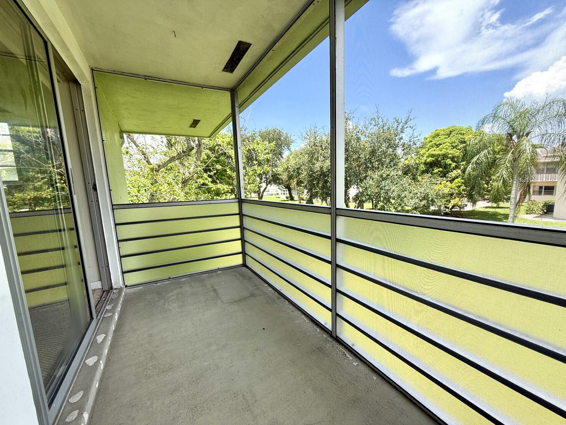 69 Norwich C West Palm Beach, FL 33417 - Photo 1 of 17 a view of a green field with wooden stairs