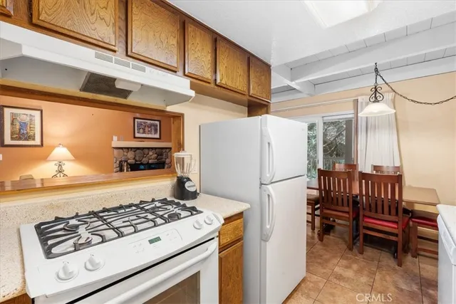 a kitchen with a stove a refrigerator and a cabinets