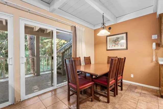 a view of a dining room with furniture wooden floor and a chandelier