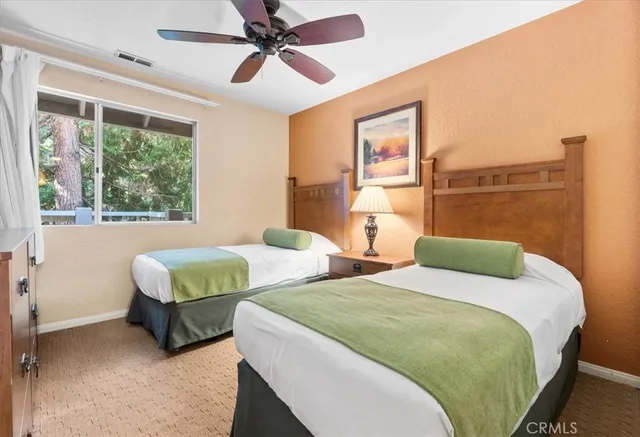 a bedroom with two beds and a window