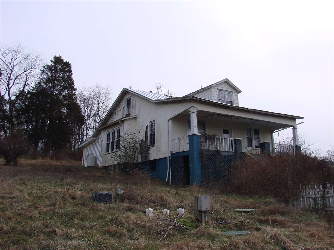 a small barn with a small yard and a large window