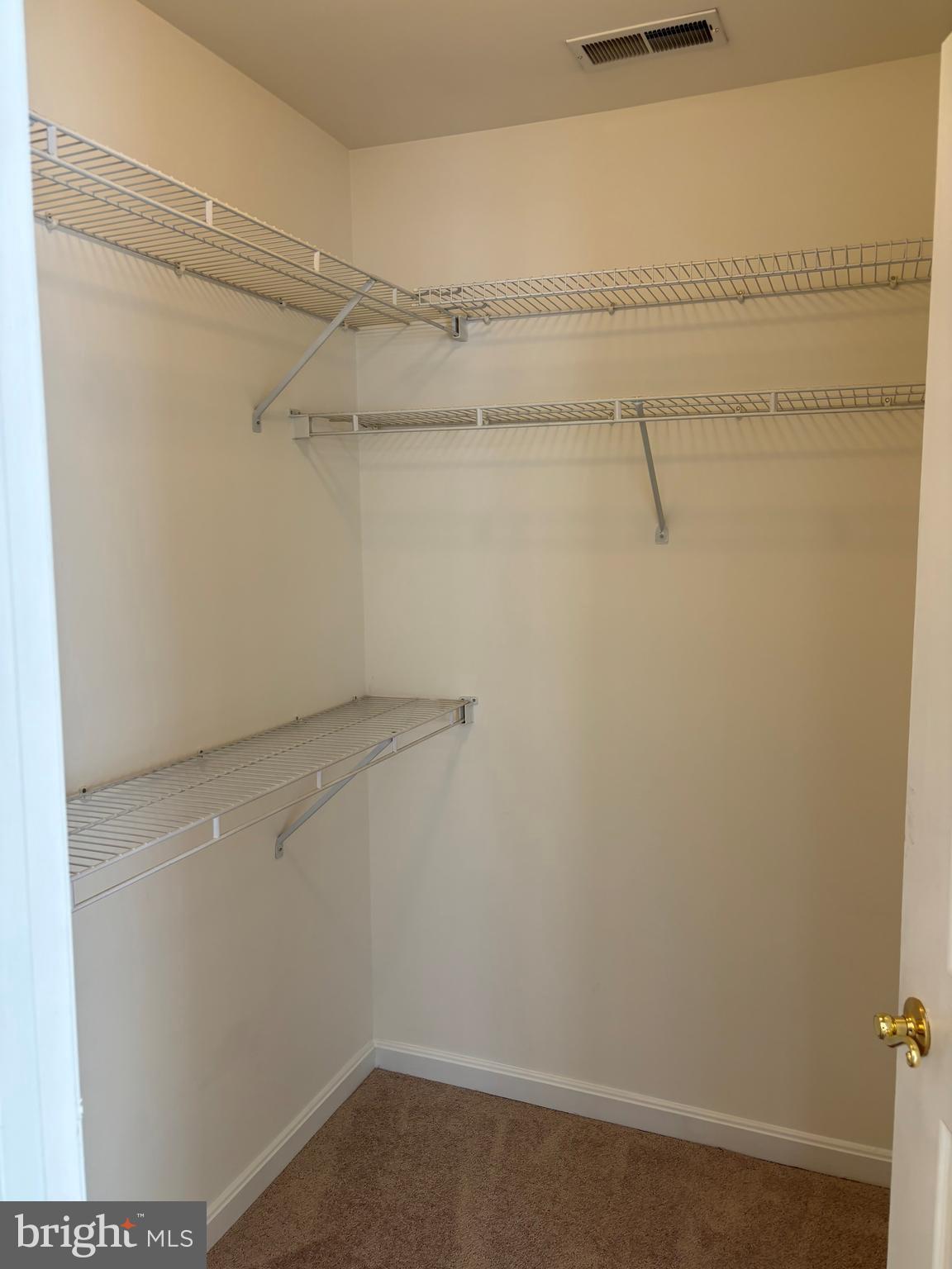 7403 Berryleaf Drive Laurel, MD 20707 - Photo 11 of 17 a view of a room with racks on the wall