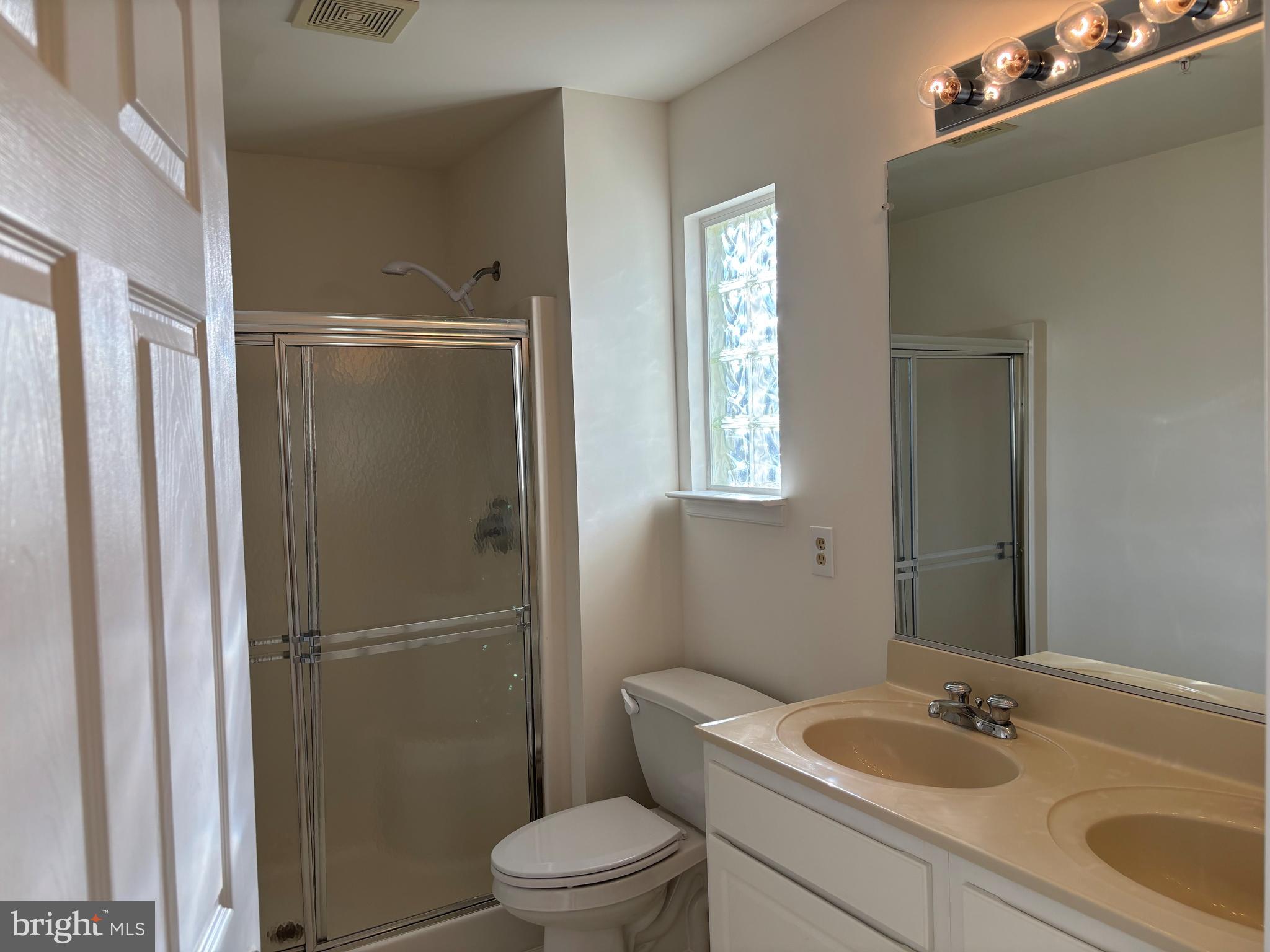 7403 Berryleaf Drive Laurel, MD 20707 - Photo 12 of 17 a bathroom with a granite countertop sink toilet and shower