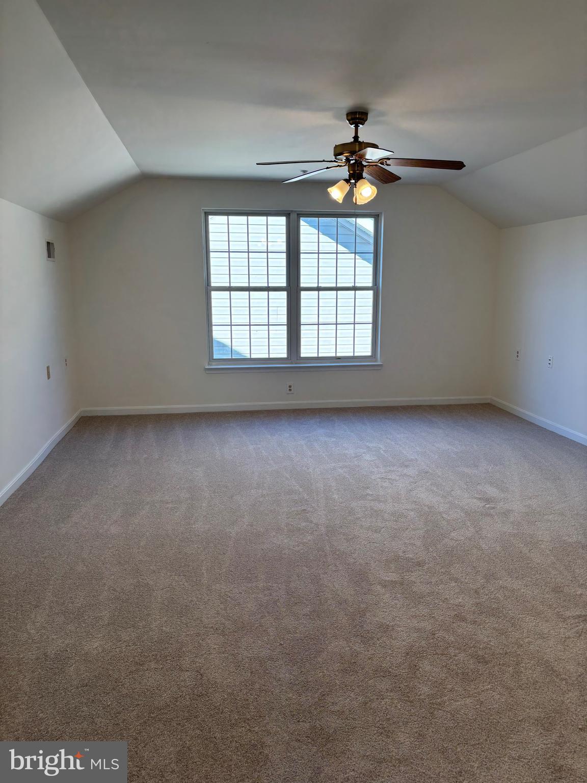 7403 Berryleaf Drive Laurel, MD 20707 - Photo 16 of 17 an empty room with a chandelier fan and windows