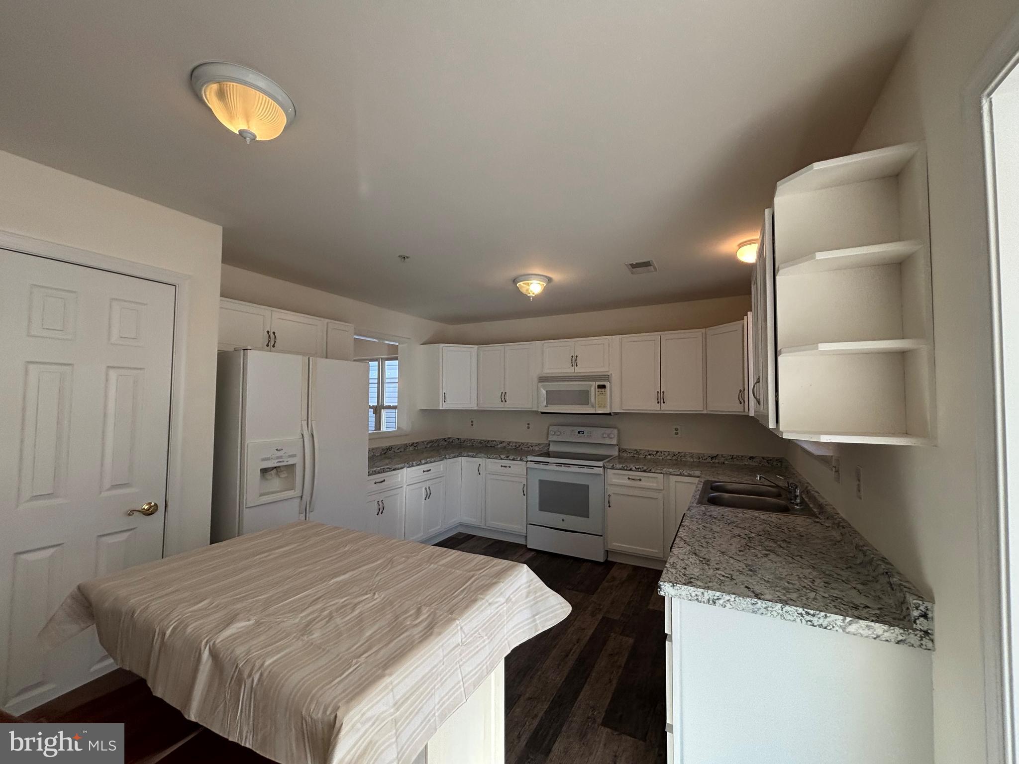7403 Berryleaf Drive Laurel, MD 20707 - Photo 8 of 17 a kitchen with a sink and a stove top oven