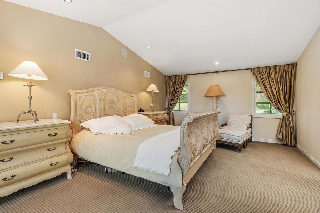 16346 Via Del Alba Rancho Santa Fe, CA 92067 - Photo 14 of 34 a bedroom with a bed and a night stand