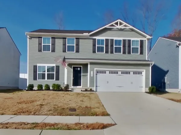 a front view of a house with a yard