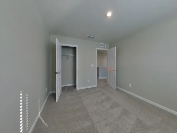 a view of an empty room with a bathroom