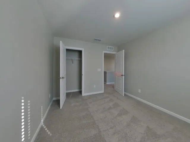 a view of an empty room with a bathroom