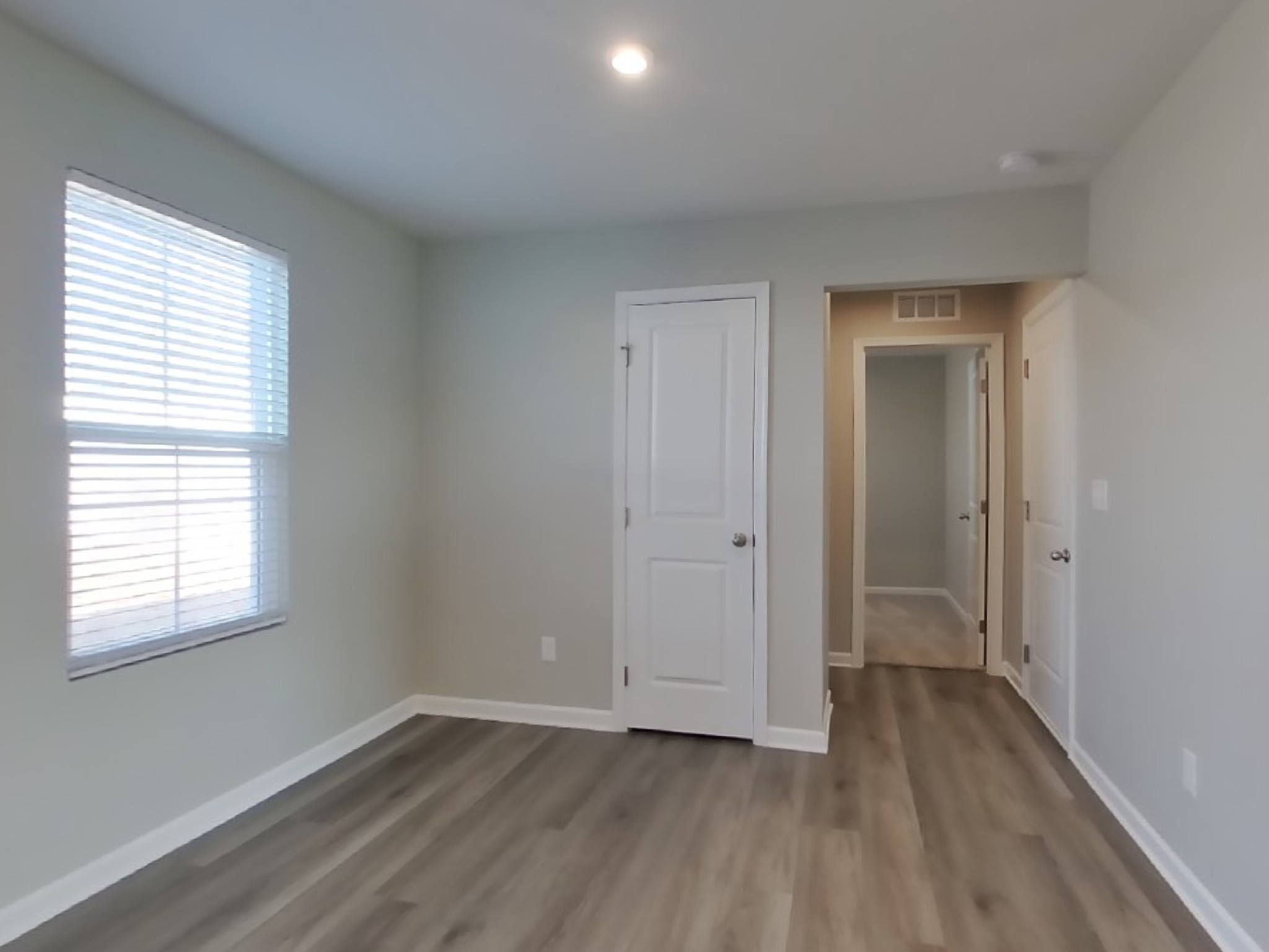 2108 Somersby Trail Spring Hill, TN 37174 - Photo 4 of 18 a view of an empty room with wooden floor and a window