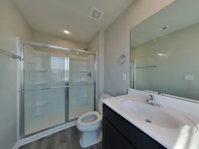 a bathroom with a sink shower and a toilet