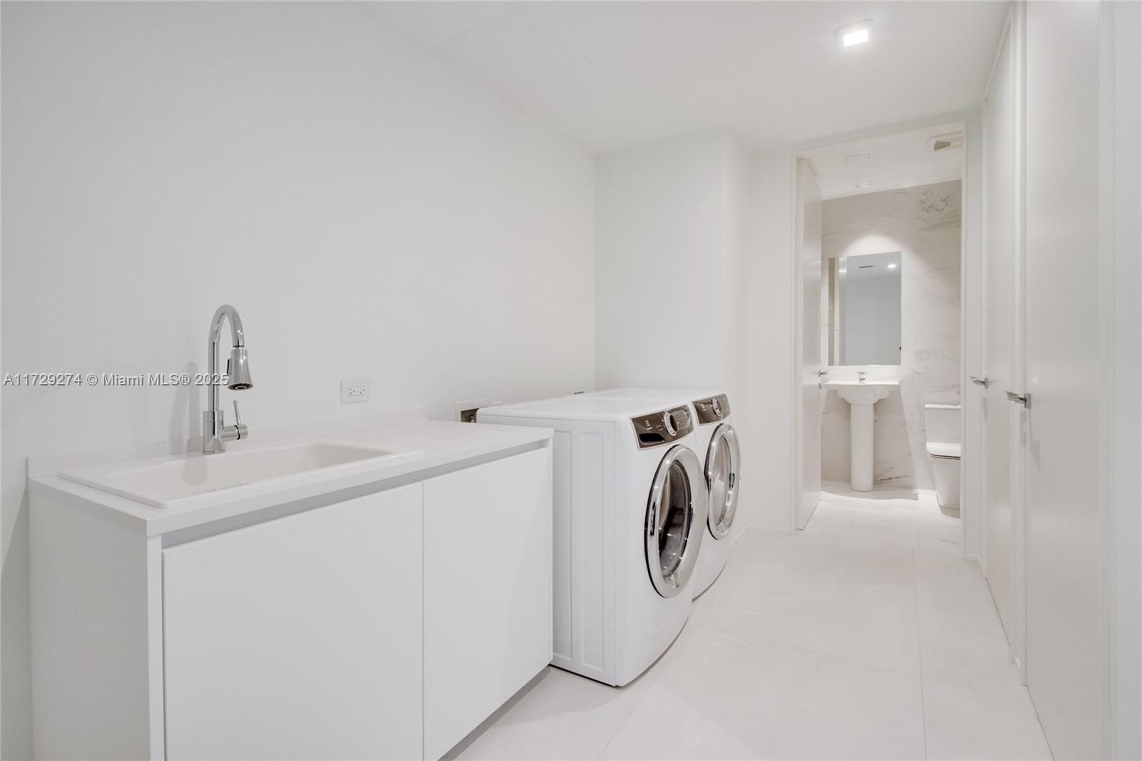 1000 Biscayne Boulevard, Unit 2302 Miami, FL 33132 - Photo 14 of 24 a utility room with dryer and washer