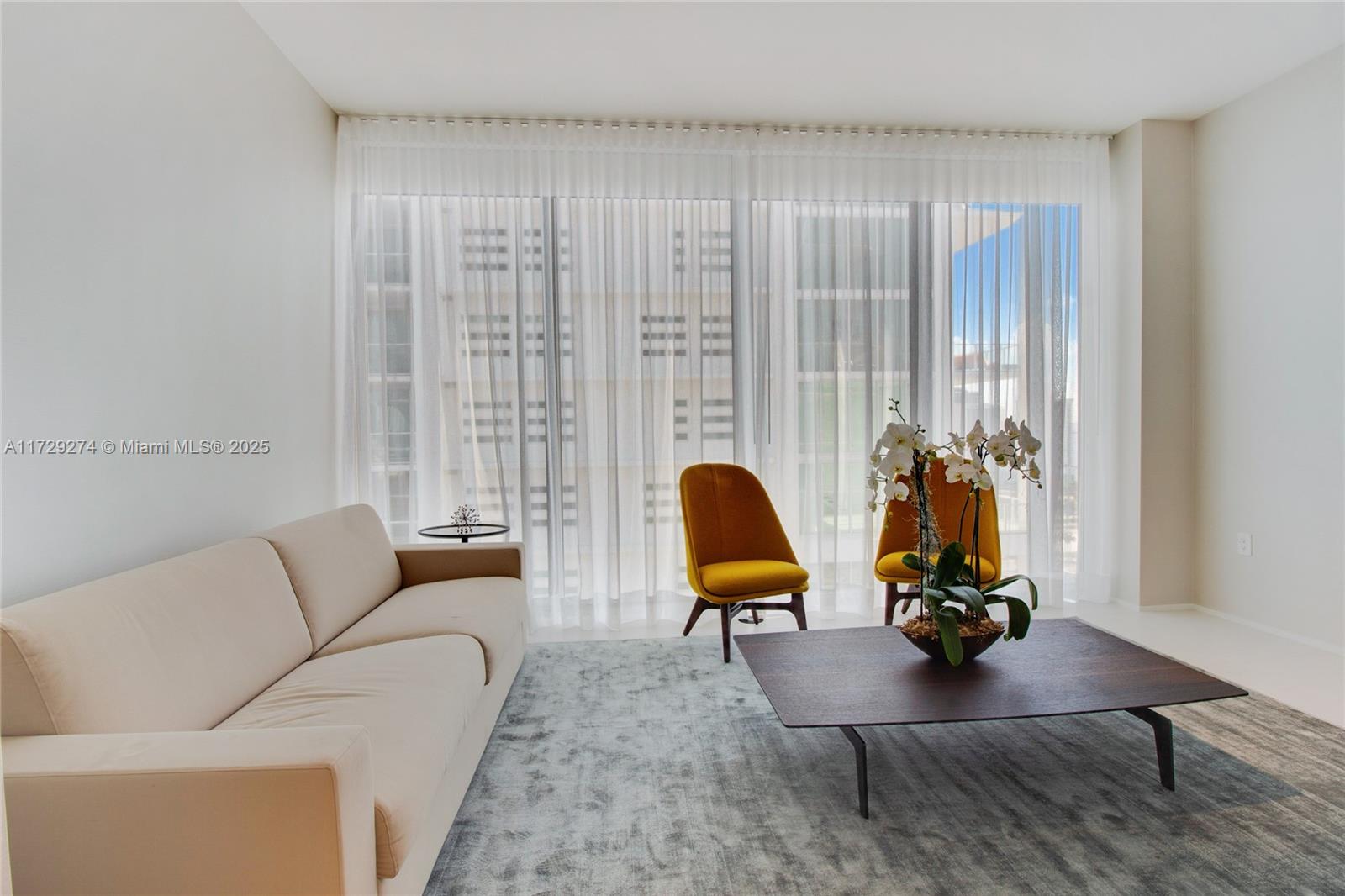 1000 Biscayne Boulevard, Unit 2302 Miami, FL 33132 - Photo 16 of 24 a living room with furniture and a large window