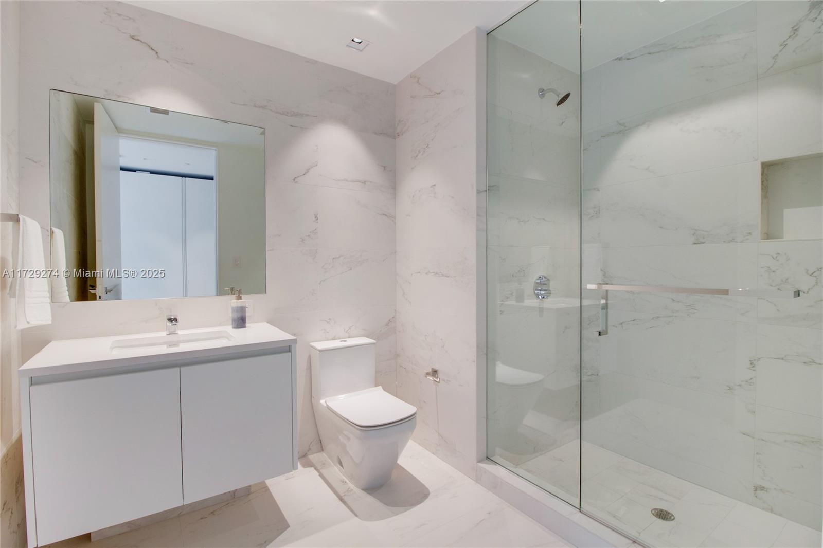 1000 Biscayne Boulevard, Unit 2302 Miami, FL 33132 - Photo 17 of 24 a bathroom with a toilet sink and shower