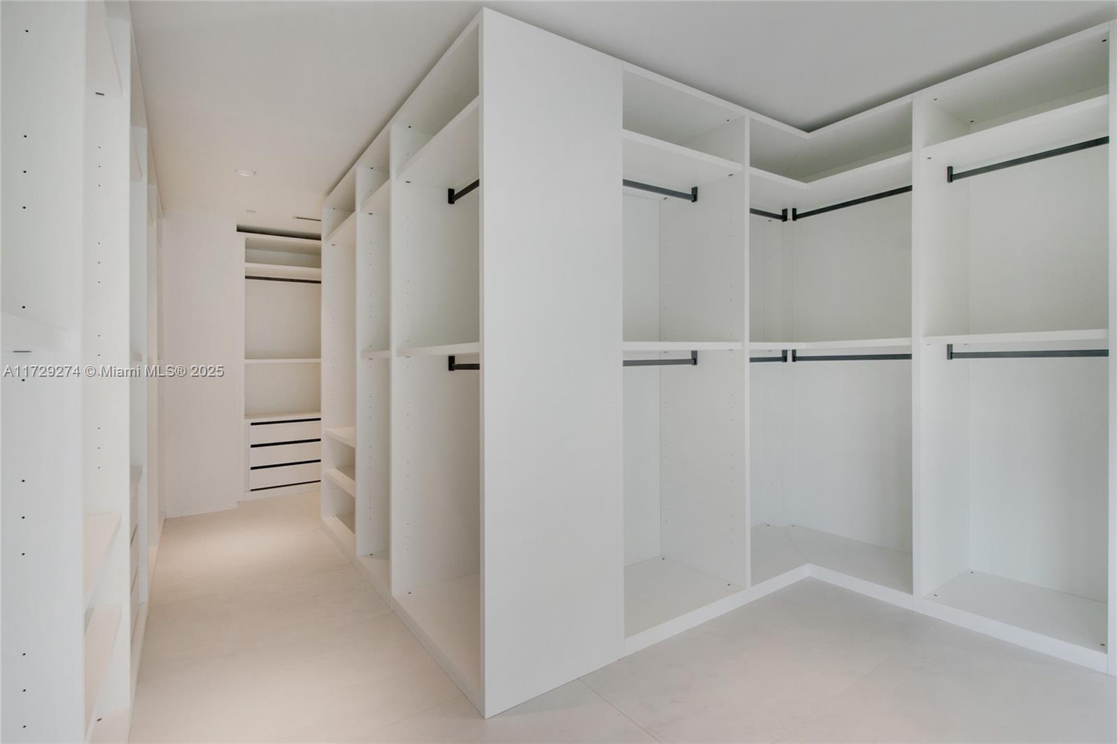 1000 Biscayne Boulevard, Unit 2302 Miami, FL 33132 - Photo 20 of 24 a view of walk in closet with empty racks