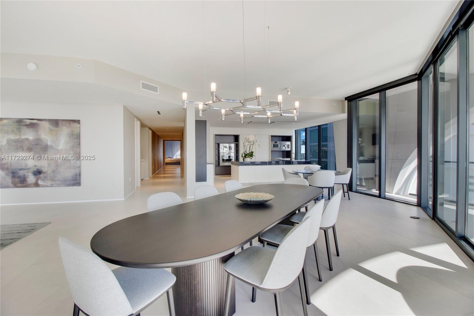 1000 Biscayne Boulevard, Unit 2302 Miami, FL 33132 - Photo 5 of 24 a dining room with furniture a chandelier and wooden floor