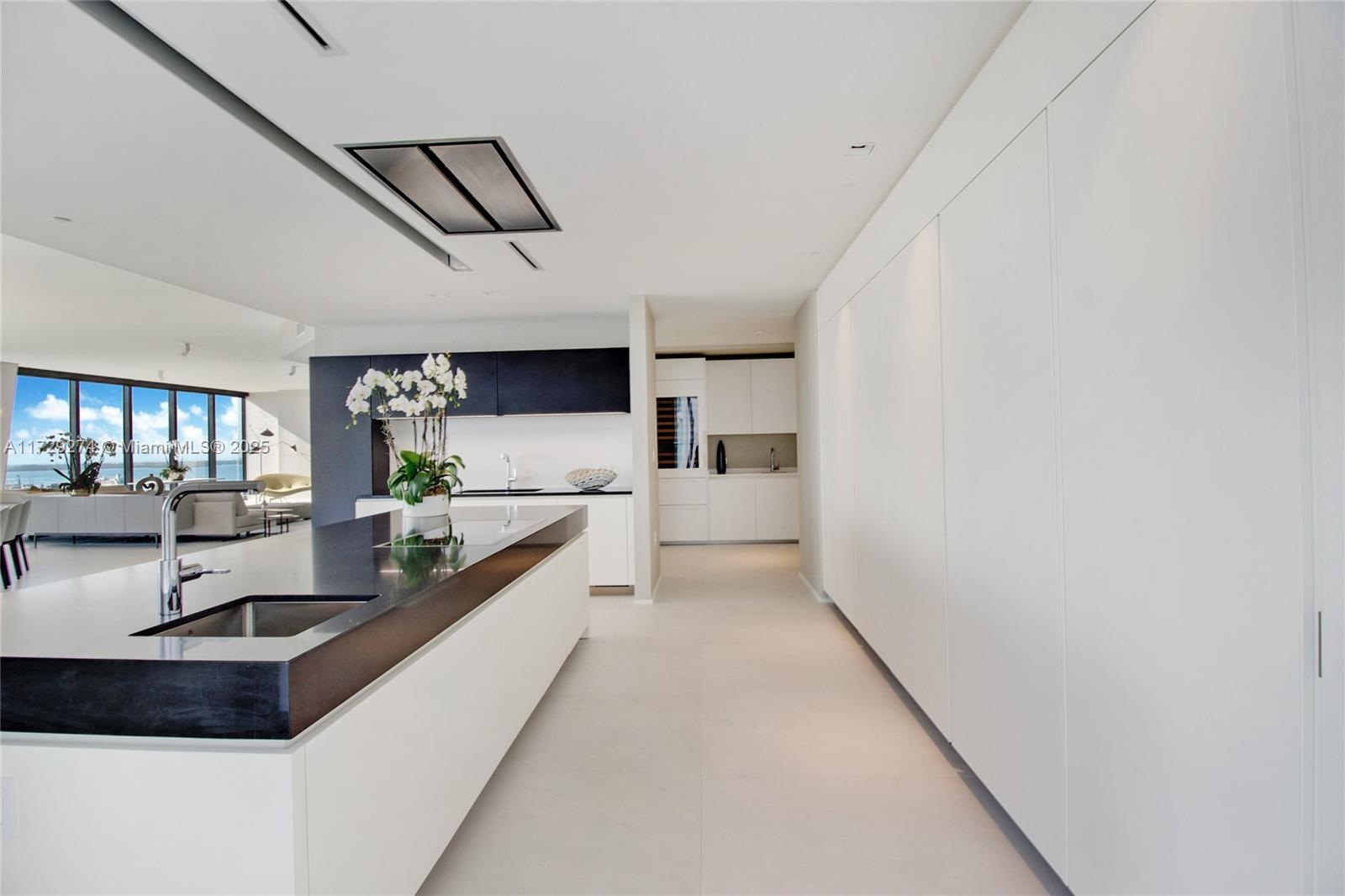 1000 Biscayne Boulevard, Unit 2302 Miami, FL 33132 - Photo 9 of 24 a large white kitchen with a large window