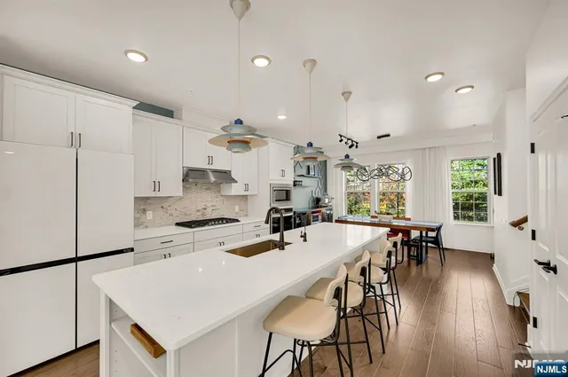 a large kitchen with a table and chairs