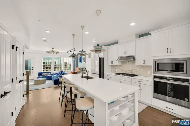 a kitchen with a table chairs stove and cabinets