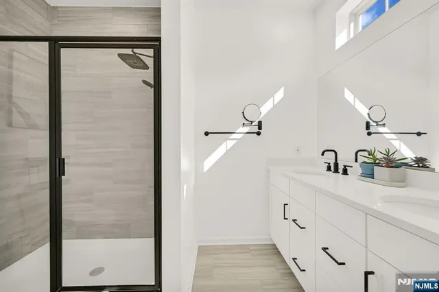a bathroom with a shower sink and mirror