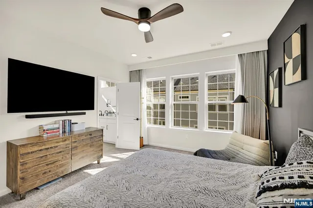 a bedroom with furniture and flat screen tv