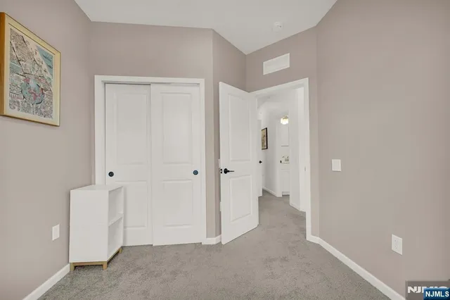 a view of an empty room and closet area