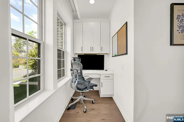 a view of workspace with wooden floor windows