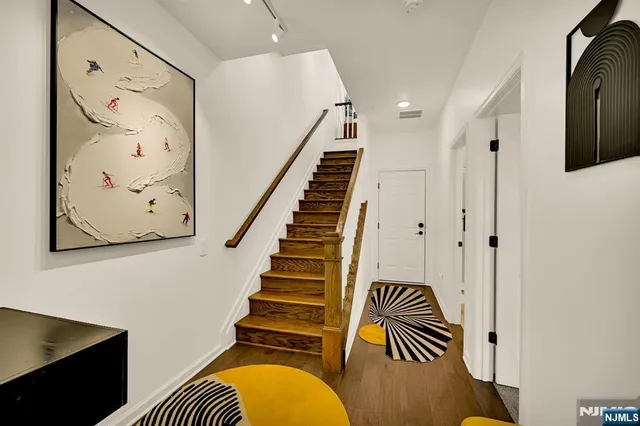 a view of entryway with stairs and wooden floor