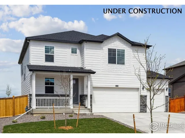 a view of a house with wooden fence