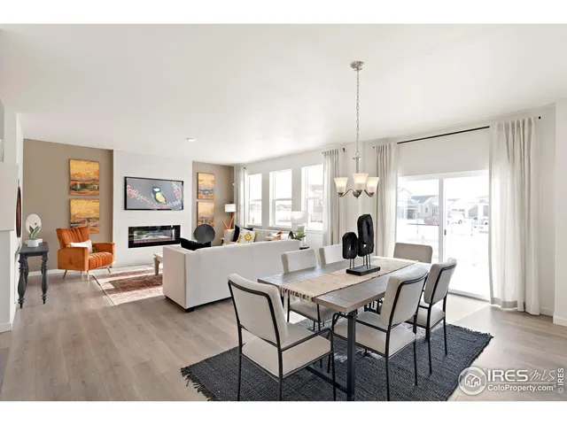 a dining room with furniture wooden floor a chandelier