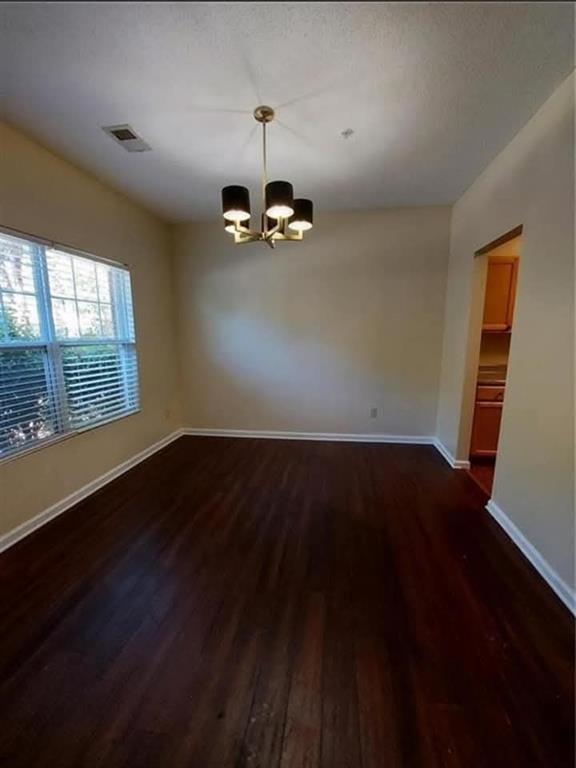 1749 Broad River Road Atlanta, GA 30349 - Photo 3 of 10 wooden floor in an empty room with a window