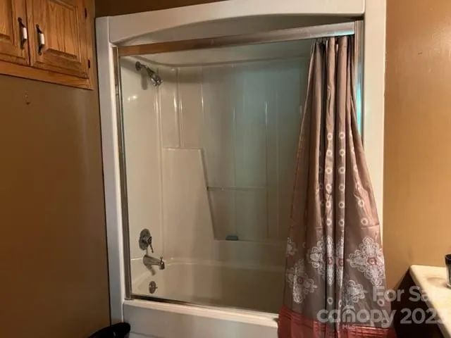 a bathroom with a bathtub and a shower
