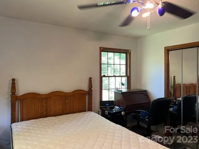 a bedroom with a bed and dresser