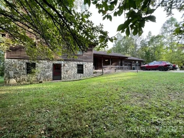 a view of a house with backyard porch and sitting area