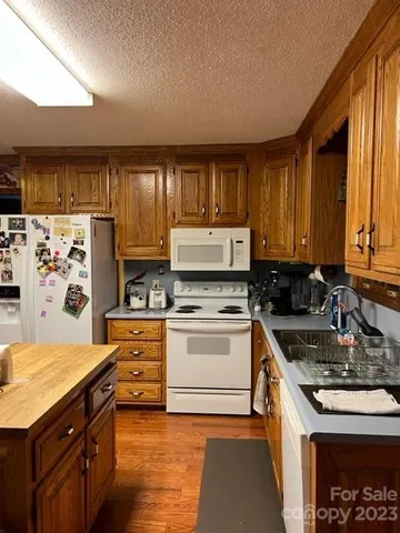 a kitchen with a stove a sink and a refrigerator