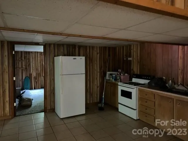 a kitchen with a refrigerator and a stove