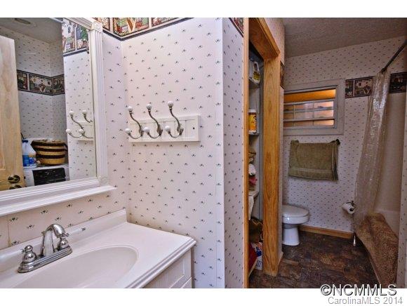 205 Souther Road Fletcher, NC 28732 - Photo 12 of 16 a bathroom with a sink and a mirror