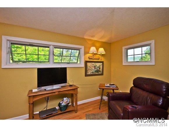 205 Souther Road Fletcher, NC 28732 - Photo 5 of 16 a living room with furniture a flat screen tv and a window