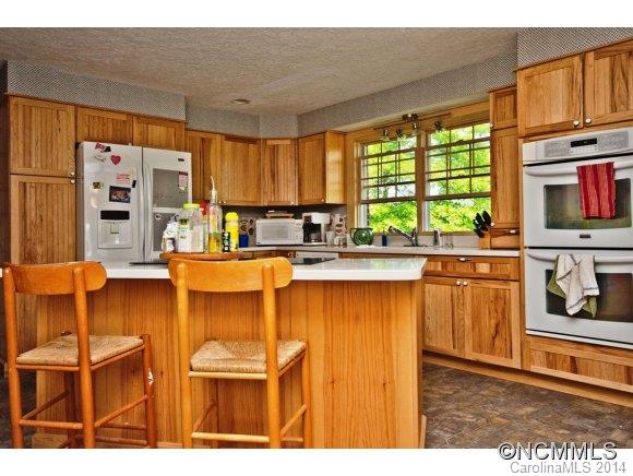 205 Souther Road Fletcher, NC 28732 - Photo 6 of 16 a kitchen with stainless steel appliances kitchen island granite countertop a refrigerator and microwave