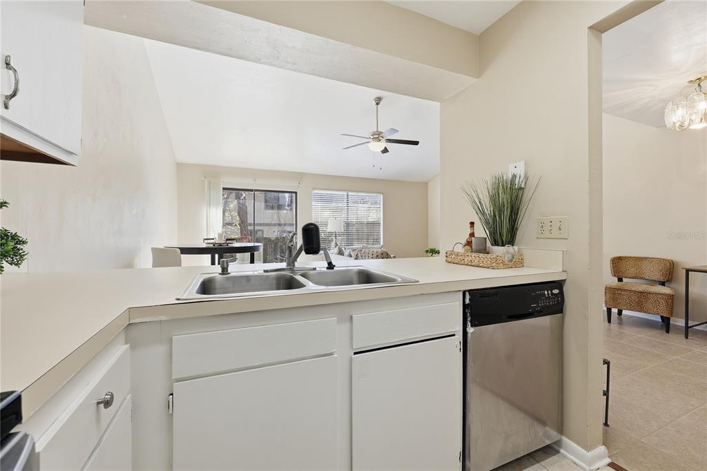4427 Southwest 21st Lane Gainesville, FL 32607 - Photo 11 of 36 a kitchen with a sink and a mirror