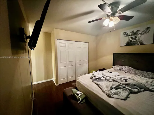 a bedroom with a bed and a ceiling fan