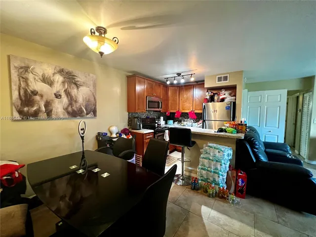 a living room with lots of furniture and paintings on the wall