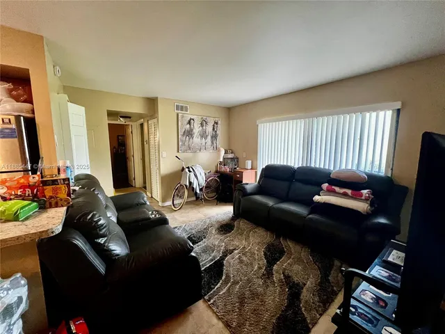 a living room with furniture rug and a window