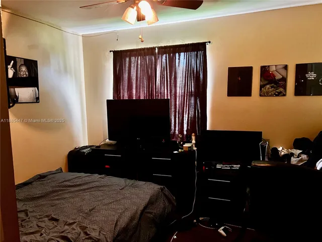 a bedroom with a bed and a television