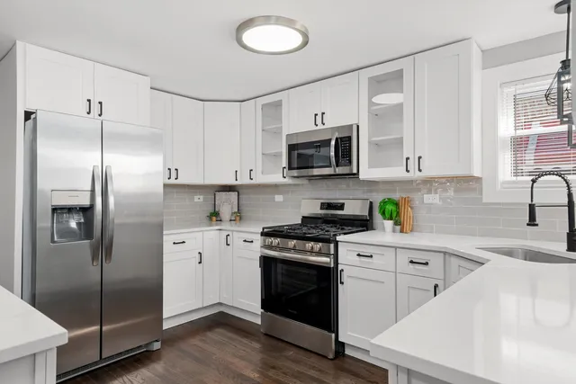 a kitchen with stainless steel appliances a refrigerator sink and microwave