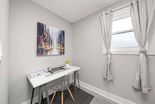 a view of a room with a table and chairs
