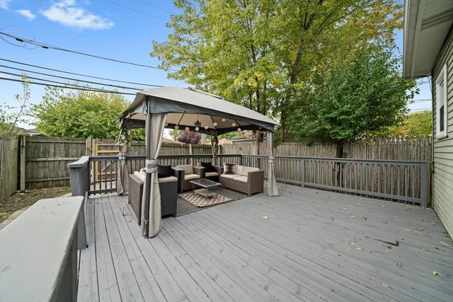 a view of a deck with wooden floor and outdoor seating